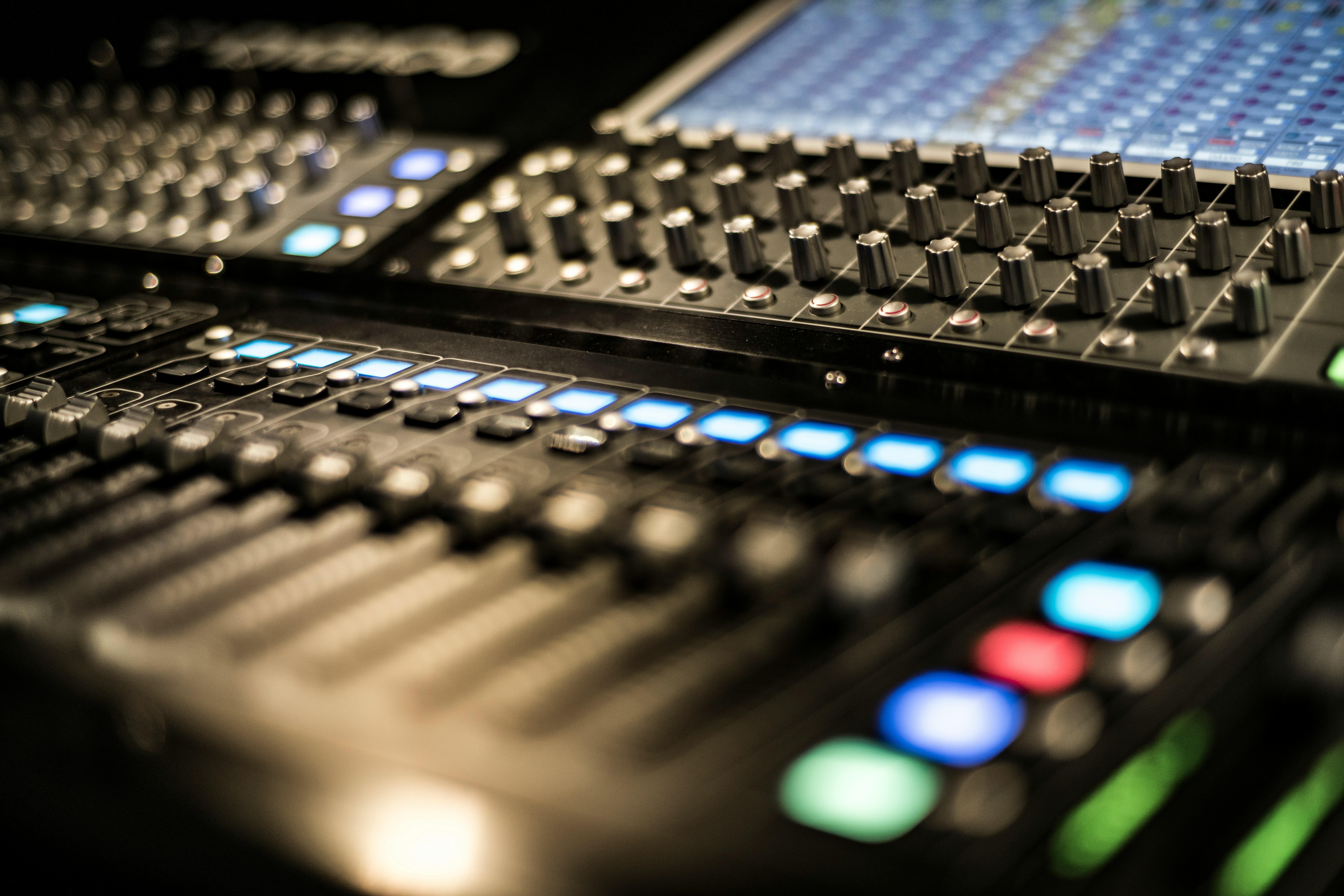 Photo of a sound mixing board from a digonal angle, close-up